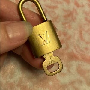 Authentic Louis Vuitton lock and key number 432. Some scratches gently loved.